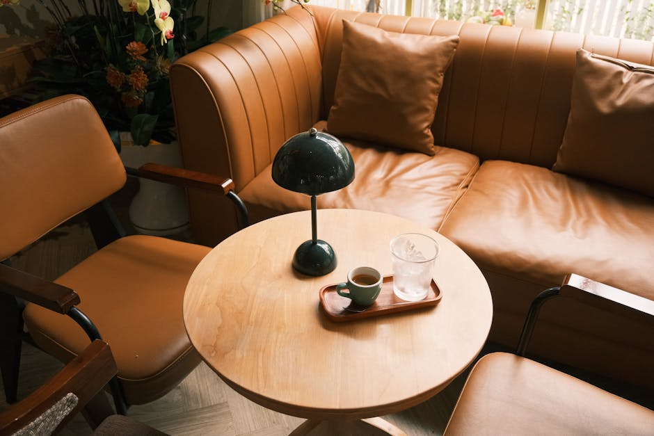 A warm living room scene with leather armchairs, a coffee table, and a stylish lamp.