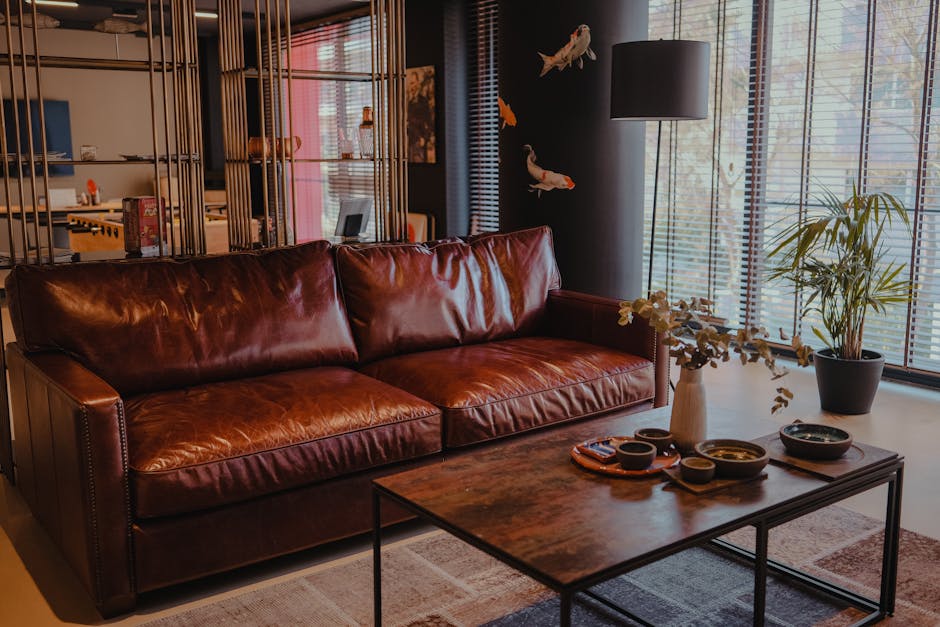 Cozy living room with a brown leather sofa and stylish decor elements.